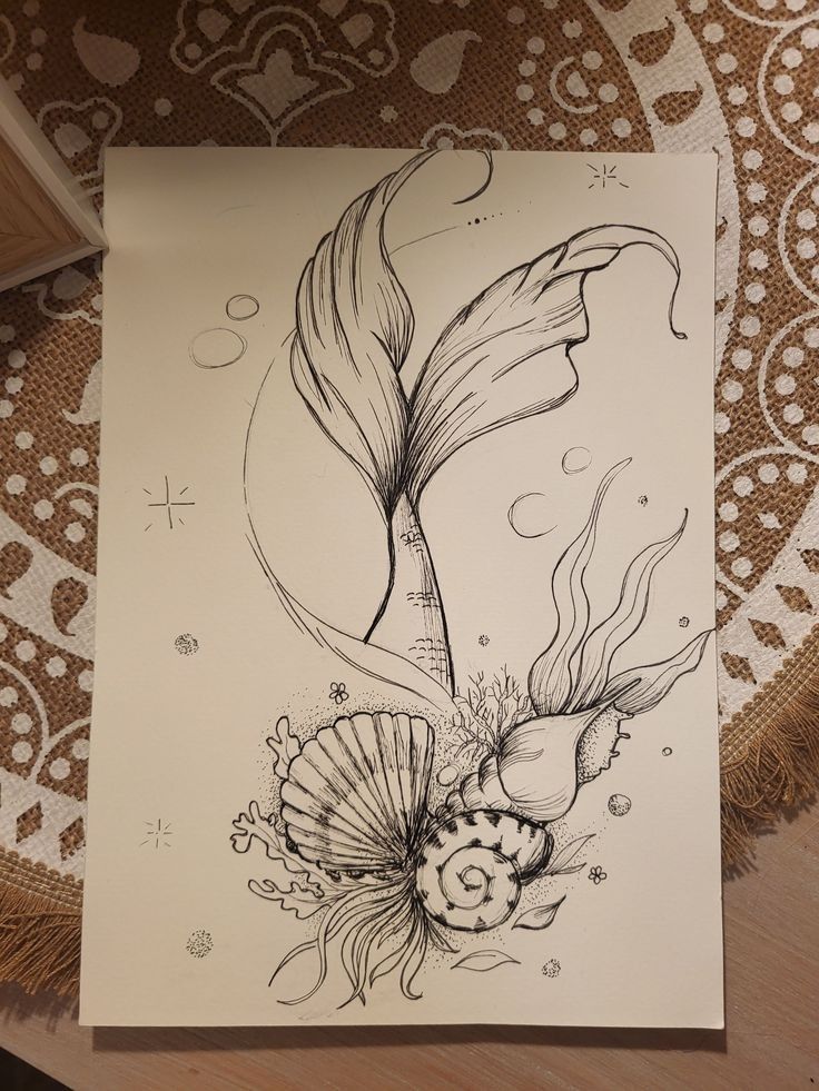 a drawing of a fish and flowers on paper