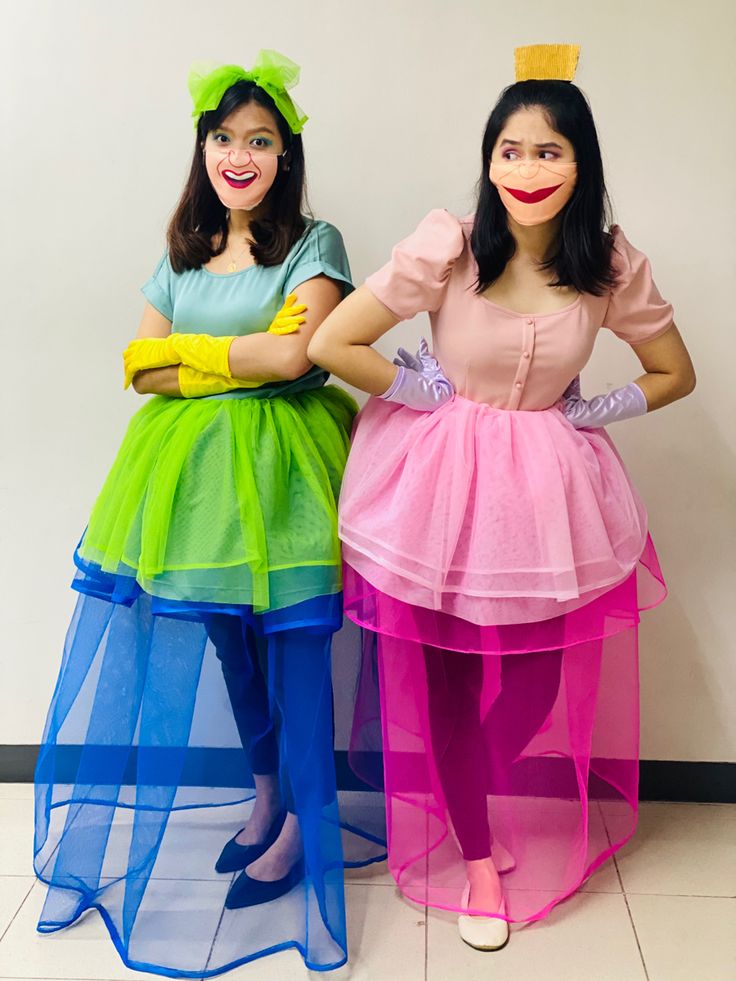 two women dressed in costume standing next to each other with their hands on their hipss