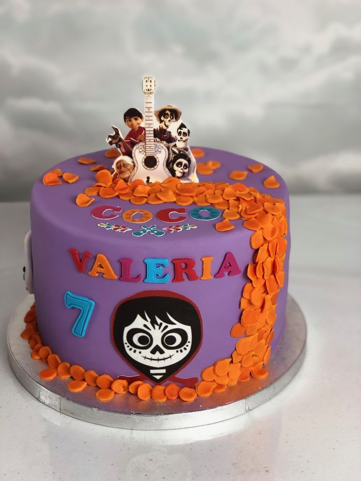 a purple cake with orange and black decorations