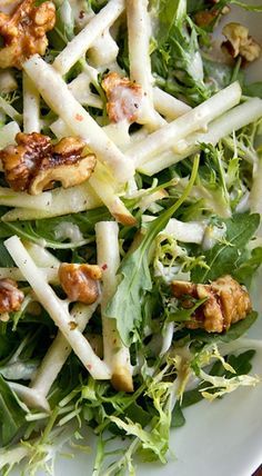 a salad with nuts and greens in it