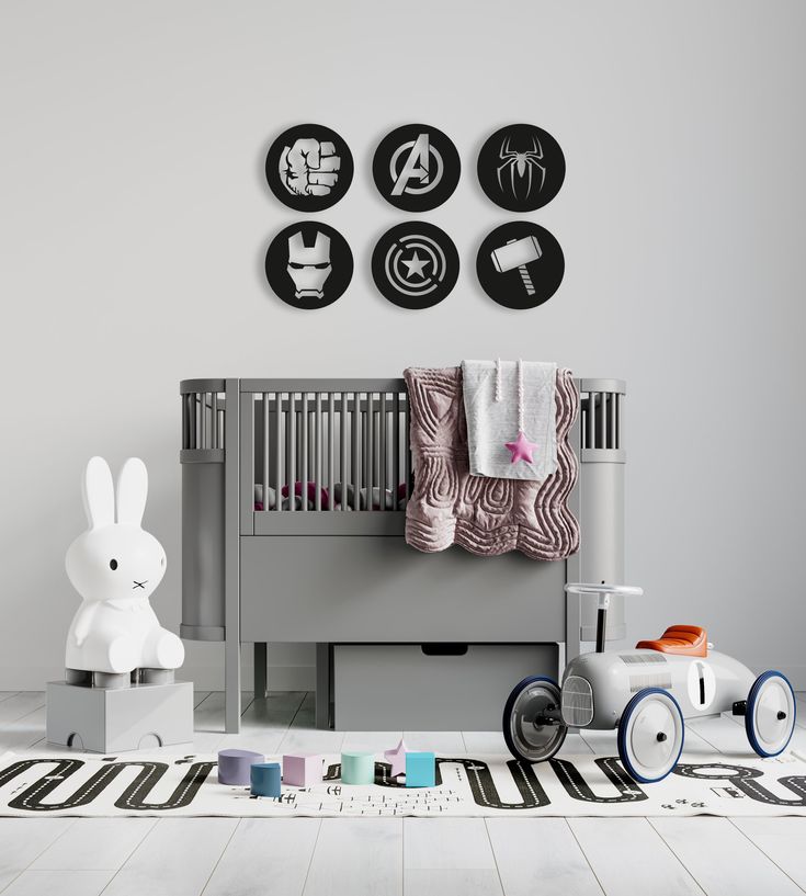 a baby's room with various items on the floor and wall, including a crib