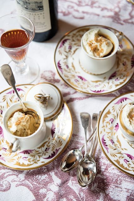 there are two cups and saucers on the table with silverware in front of them