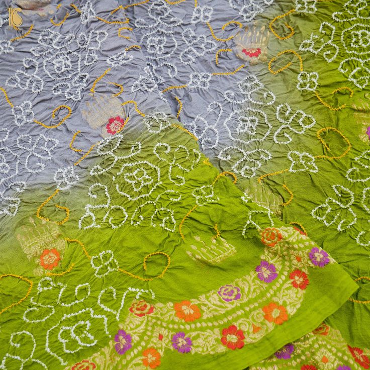 Add a dash of color to your ethnic look with this beautiful Banarasi Handloom Bandhani dupatta. The dupatta is made of pure Georgette and has the illustrious jaal and Bandhani work from Kutch. Jaal's work is inherent to Banarasi weaving, and this dupatta is the epitome of the craftsmanship of the renowned weavers of Banaras. Fabric - Pure Georgette Silk - Georgette is a lightweight, crinkled, sheer fabric that displays an overall bouncy look. A strong absorbent, Georgette is easy to dye and has Floor-length Georgette Dupatta With Bandhani Print, Yellow Georgette Dupatta With Bandhani Print, Transitional Bandhani Print Georgette Dupatta, Yellow Bandhani Print Georgette Dupatta, Yellow Semi-stitched Dupatta With Bandhani Print, Ethnic Looks, Sheer Fabrics, Color Variations, Green And Grey