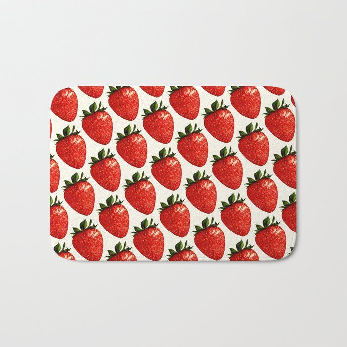 a bath mat with strawberries all over it