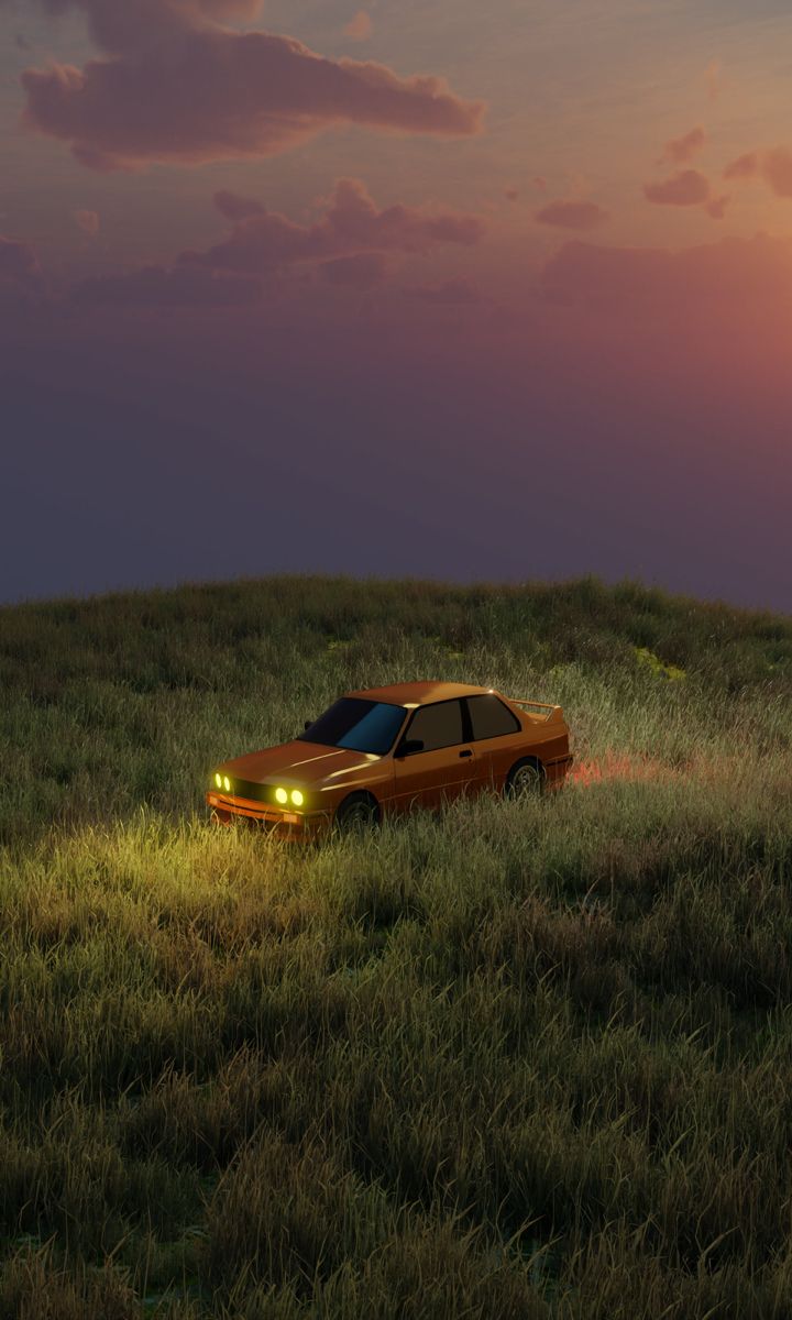 an orange car is driving through the grass at sunset or dawn with its headlights on