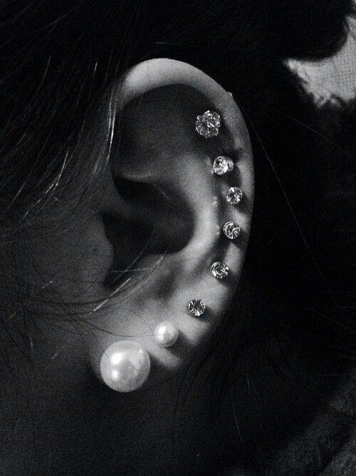 black and white photograph of a woman's ear with pearls