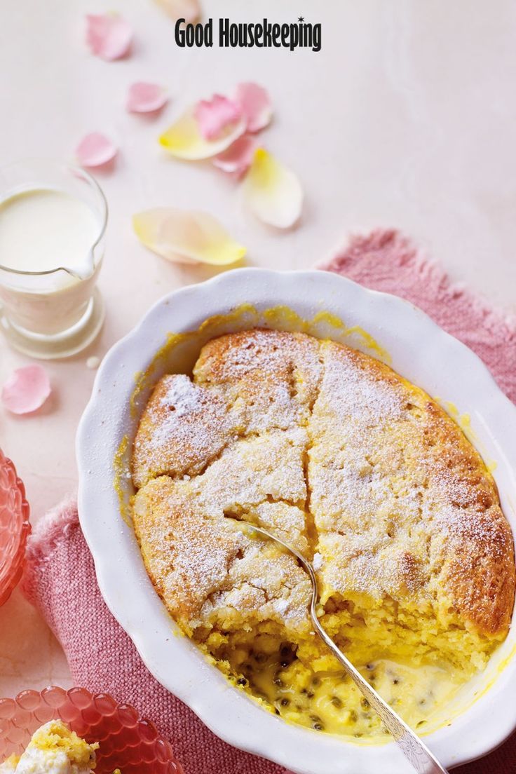 a close up of a pie in a bowl on a table next to some flowers