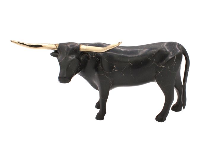 a black bull statue with long horns on it's head is standing in front of a white background