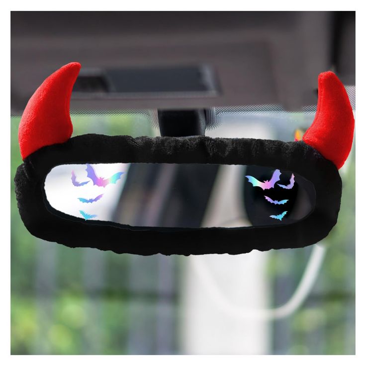 a car mirror with red horns and bats on it's side view mirror cover