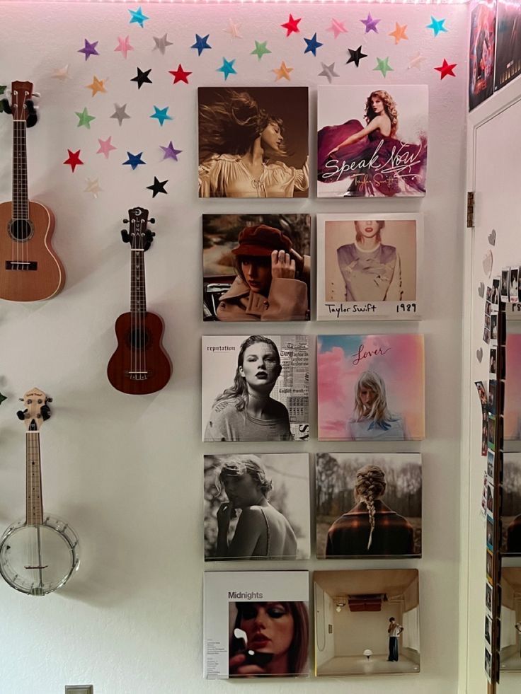 there is a wall with many pictures on it and a guitar hanging from the wall