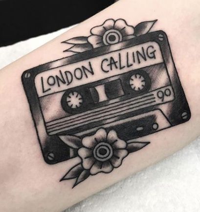 a black and white photo of an old school style tattoo with the words london calling on it