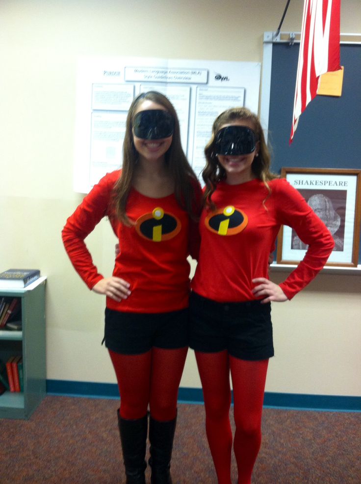 two women in red shirts and black shorts are standing next to each other with their hands on their hipss