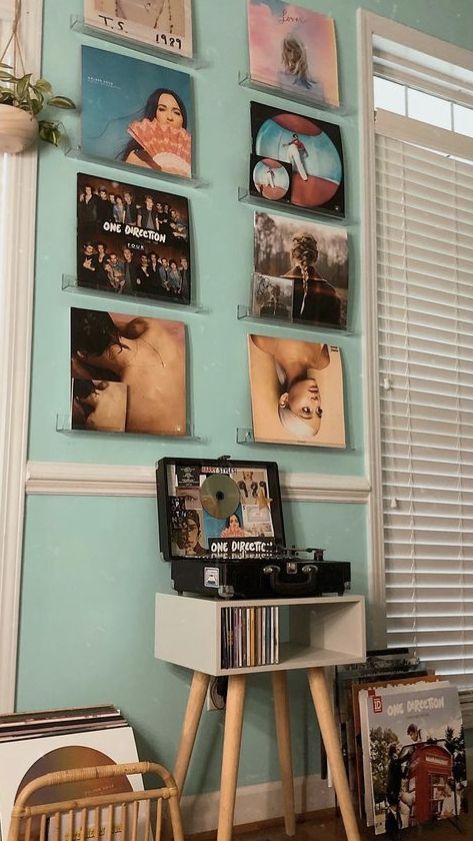 there are many pictures hanging on the wall in this room, and one has a record player next to it