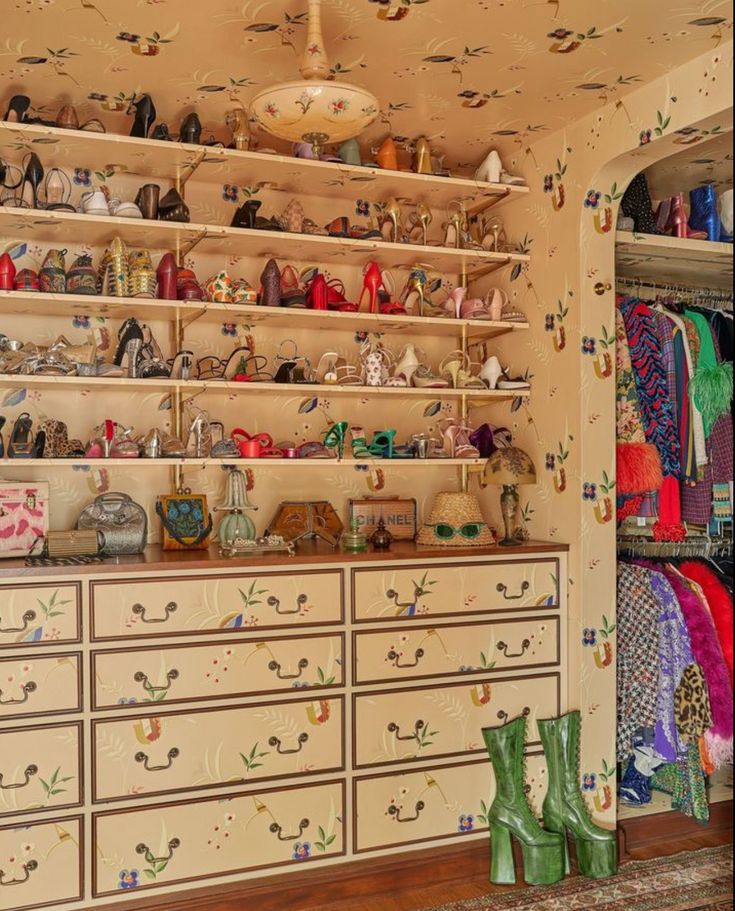 the closet is full of shoes and purses, including one in green booties