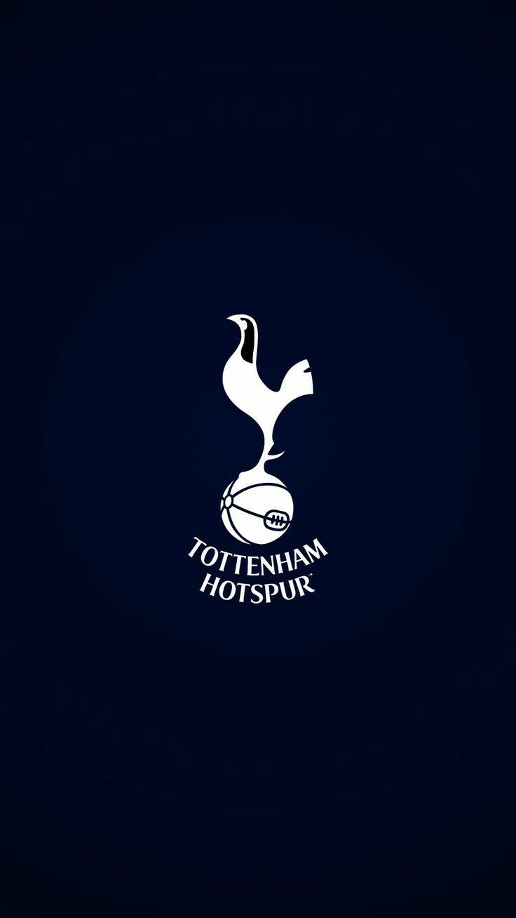 the tottenham logo on a dark background