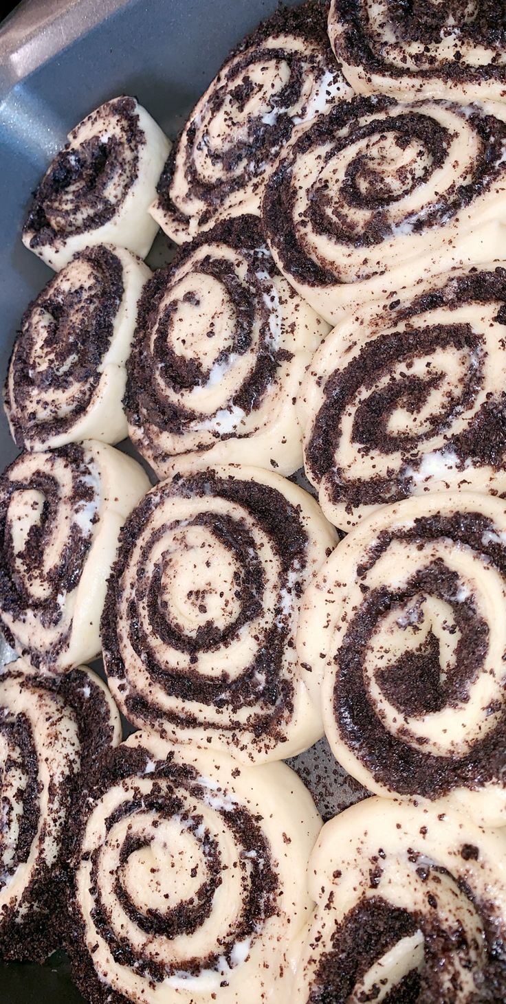 a pan filled with cinnamon rolls covered in icing