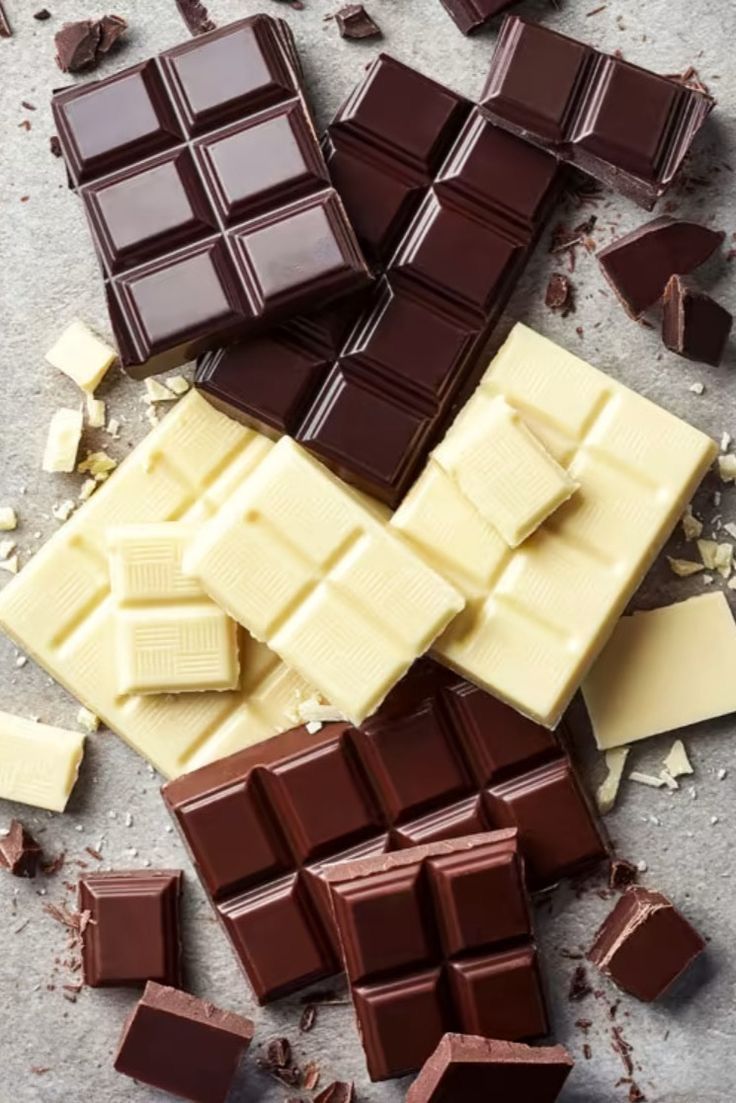 several pieces of chocolate sitting next to each other on top of a table covered in debris