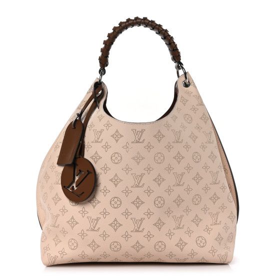 This is an authentic LOUIS VUITTON Mahina Carmel Hobo in Creme. This chic shoulder bag is crafted of fine mahina leather in light beige. The shoulder bag features a brown braided top handle and polished silver hardware. The top opens to a brown microfiber interior with a zipper pocket. Beige Monogram Canvas Shoulder Bag With Leather Handles, Luxury Hobo Bag With Leather Handles, Everyday Luxury Beige Bags With Leather Handles, Beige Bags With Leather Handles For Everyday Luxury, Luxury Brown Hobo Bag For Shopping, Designer Beige Hobo Bag With Detachable Handle, Designer Beige Hobo Bag With Double Handle, Luxury Cream Hobo Bag For Shopping, Cream Monogram Canvas Shoulder Bag For Everyday Use