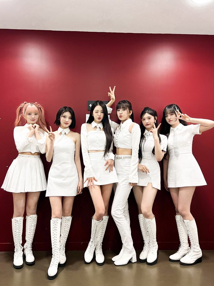 the girls are posing in white outfits