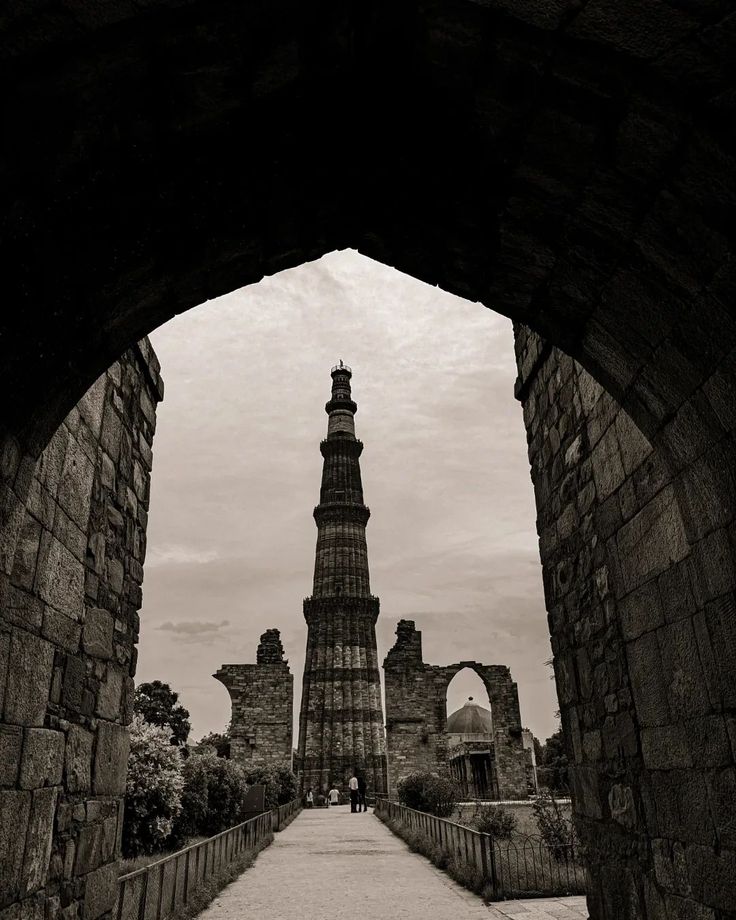 an archway leading to a tall tower with a clock on it