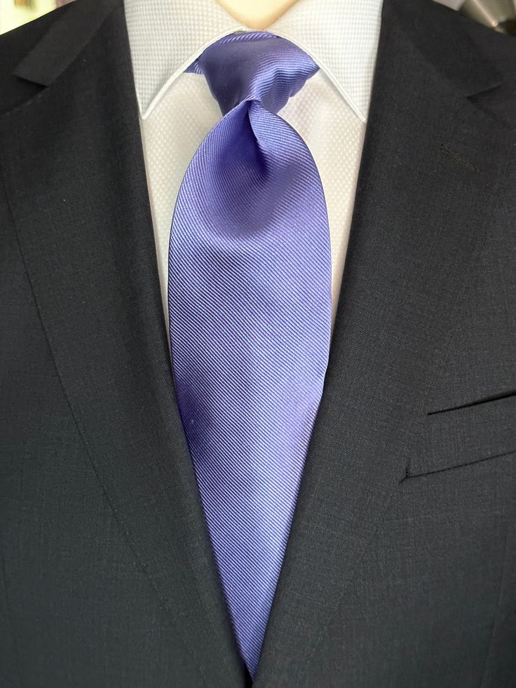 Solid ties are beautifully paired with the more busy of patters of bold stripes and heavy plaids. However, there is something so understated and elegant about a solid tie with a solid suit. Whether that be navy, charcoal or black a lavender tie fits well with a white shirt and even a navy blazer with jeans. Classic Formal Suits With Ties, Tailored Workwear Suit And Tie Accessories, Elegant Business Suits, Dapper Solid Color Ties, Elegant Purple Formal Suit, Elegant Purple Suit For Formal Occasions, Tailored Suits With Standard Tie For Office, Dapper Solid Color Ties For Business, Solid Dapper Ties For Formal Occasions