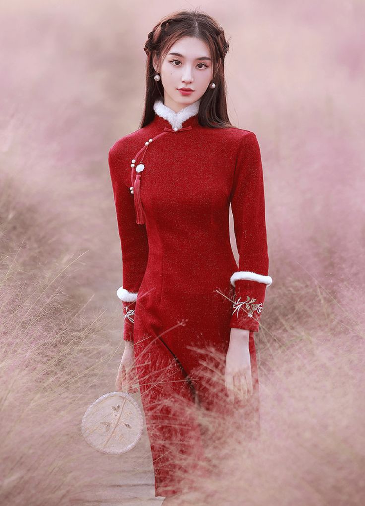 Color: red Silhouette: A-line Length: medium Neckline: mandarin collar Sleeves: long Fabric: velvet Material: polyester Details: floral embroidery on the sleeves A winter qipao in a festive color Stay warm and elegant with our unforgettable winter qipao. Made with quality velvet, this charming Chinese dress will keep you feeling cozy and comfortable in colder weather. The fabric of the dress is soft to the touch and pleasant to wear. The iconic color of this qipao winter dress will create a capt Elegant Embroidered Ao Dai With Stand Collar, Traditional Red Fall Dresses, Elegant Embroidered Festive Cheongsam, Traditional Red Winter Dress, Elegant Embroidered Cheongsam With Stand Collar, Red Fitted Ao Dai With Stand Collar, Traditional Winter Festive Dresses, Traditional Festive Winter Dresses, Elegant Long Sleeve Embroidered Ao Dai