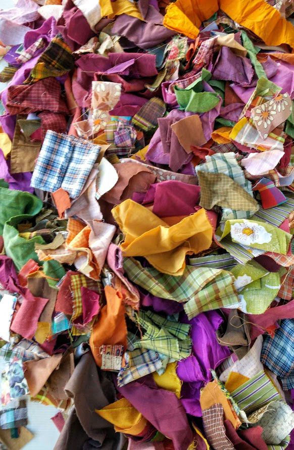 a pile of multicolored cloths piled on top of each other