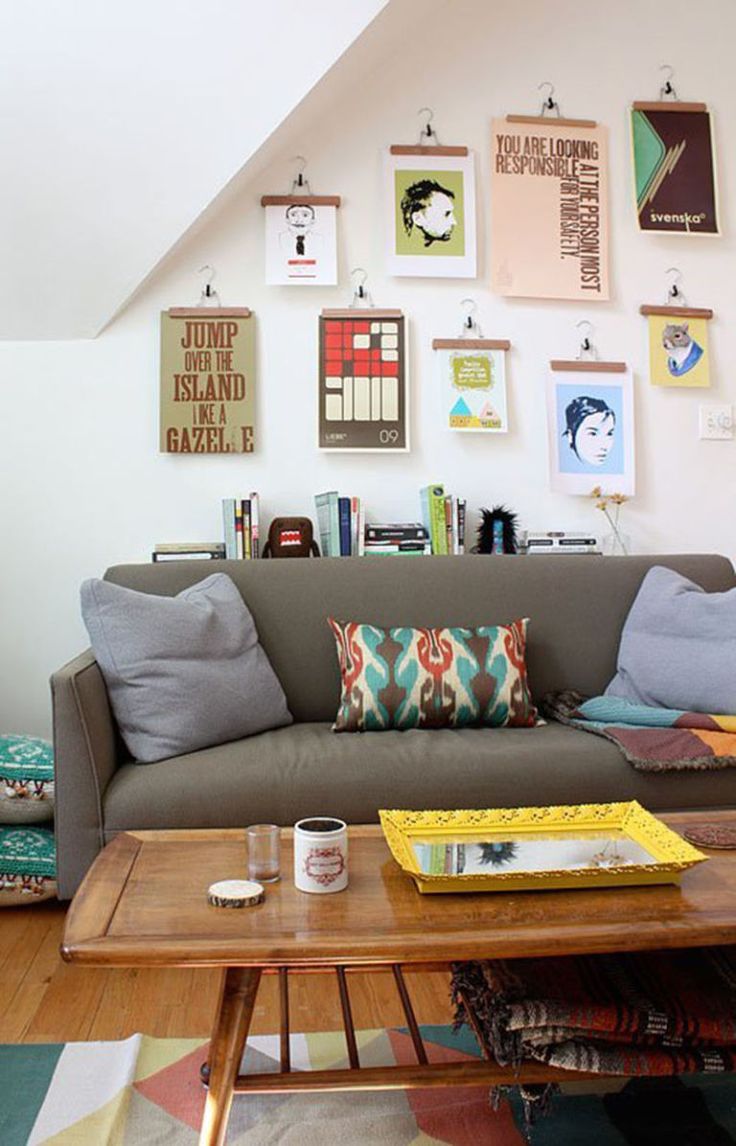 a living room filled with lots of furniture and pictures on the wall above it's coffee table