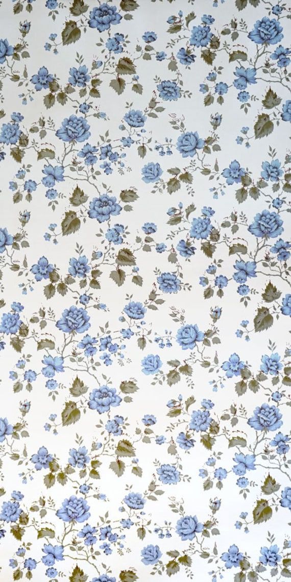 a blue flowered wallpaper with green leaves and flowers on white background is shown