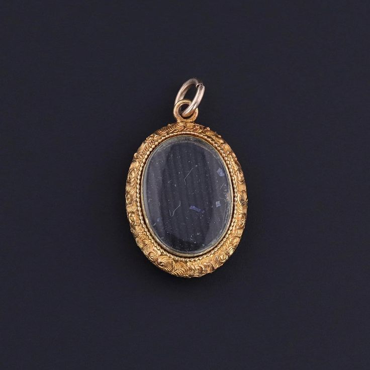 This antique, 14k gold locket (circa 1880) features a blue enamel cross, heart, and anchor representing faith, hope and charity. There is a glass compartment on the reverse that can be used to store a photo or small keepsake. The locket measures 1 inch from the top of the jump ring to bottom by 0.55 inches wide, and it is in great condition. Note: The antique box in the photo is for display purposes only and is not included with the pendant. Materials: 14k gold, Enamel. Victorian Round Pendant Jewelry For Commemoration, Victorian Keepsake Jewelry Charms, Heirloom Locket Jewelry For Commemoration, Antique Charms Jewelry For Memorial, Antique Locket Jewelry For Commemoration, Victorian Cabochon Jewelry For Memorial, Antique Locket For Commemoration, Antique Oval Jewelry For Commemoration, Oval Locket Jewelry For Commemoration