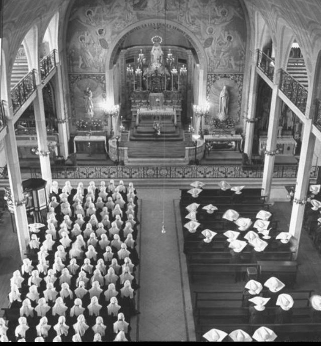 an old black and white photo of the interior of a church with rows of pews