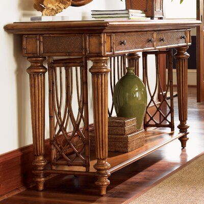 a wooden console table with a vase on top