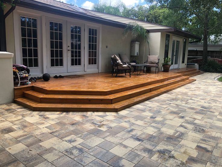 a patio with steps leading up to the back door