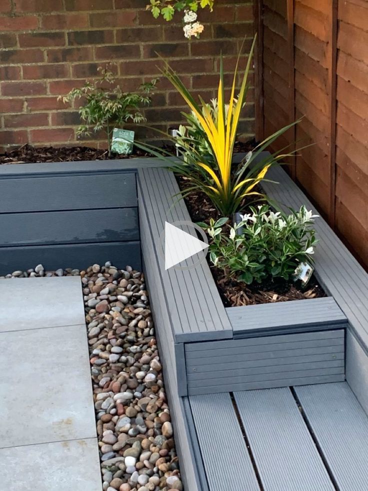 a small garden with rocks and plants in it