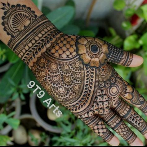 the hand is decorated with henna designs and flowers on it's palm,