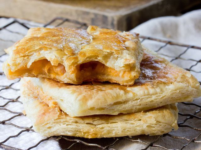 two pieces of pastry sitting on top of a cooling rack