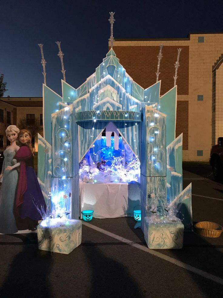 the entrance to an ice castle is decorated with blue lights and frozen snow figures,