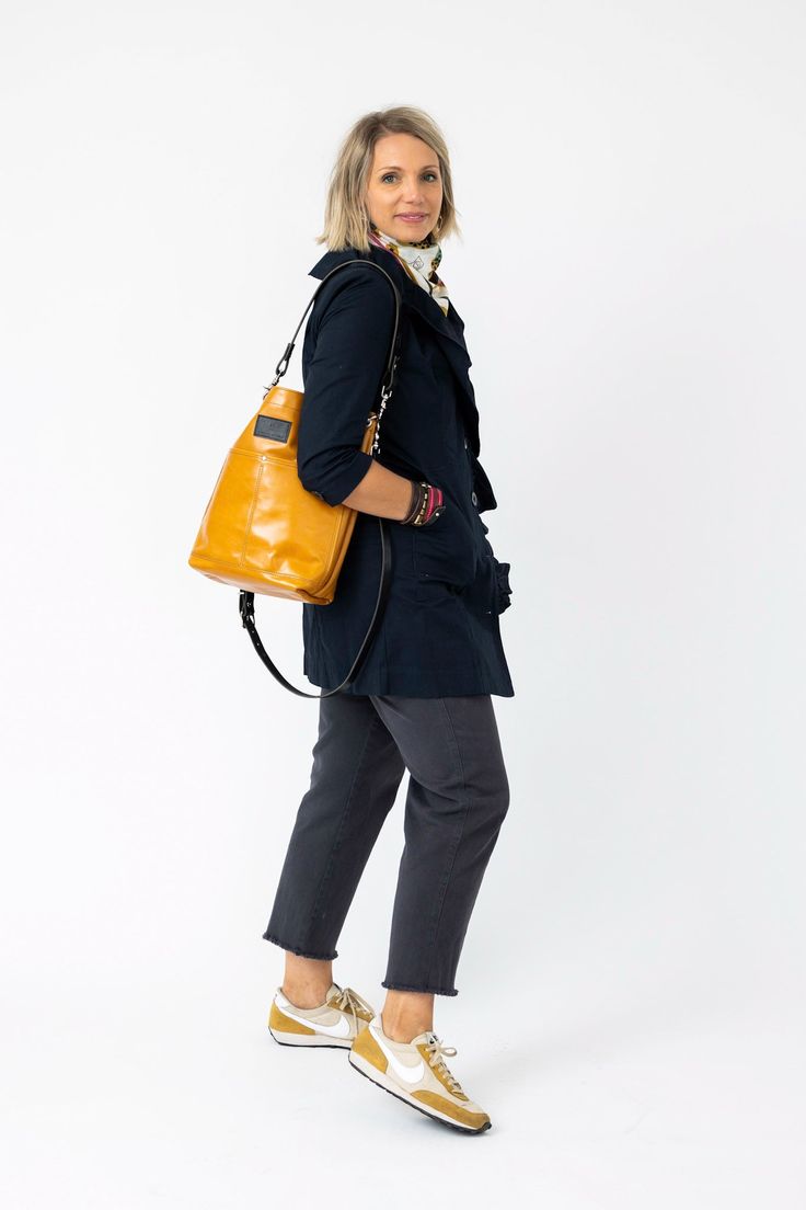 Our Everyday Collection of handbags reflects our task, offering tried + true styles + combinations that are timeless + classic. Colors + sizes to keep up with your effortless style + quality that holds up to your everyday adventures. Four outside pockets and four interior pockets make this our most functional bag., Did we mention it holds a laptop? In fine Alexis Drake fashion, the Train Tote is effortless and everyday. Available in Black + Rocky and Rocky + Navy. Dimensions : 14.75" X 14" X 4.5 Standard Backpack With Removable Pouch For Work, Chic Hobo Bag With Pockets For Daily Use, Versatile Satchel With Removable Pouch For Work, Chic Everyday Bucket Bag With Pockets, Fall Travel Bucket Bag With Detachable Strap, Functional Satchel Bucket Bag For Everyday, Everyday Hobo Bag With Pockets, Functional Everyday Satchel Bucket Bag, Chic Bucket Bag Tote With Pockets