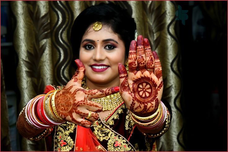 a woman with her hands painted in hendi and holding something up to the camera