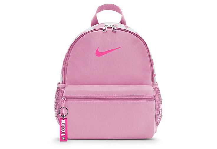 Nike Brasilia JDI Mini Women s Bag While on the go, keep the essentials in the Nike Brasilia JDI Mini women s Bag. Featuring a polyester body with JUST DO IT screen print on the top for classic Nike style, this mini zip BackPack doubles as a purse or carry-on. The side pockets hold water bottles and a JDI keychain makes sure keys are kept safe. Fabric material   Padded shoulder straps  Double-zip main compartment  JDI keychain/screen print  Side mesh pockets Pink Gym Bag For Back To School, Nike Pink Bag For Daily Use, Nike Gym Bag With Zipper Closure, Nike Nylon Bags For Back To School, Nike Pink Backpack For School, Nike Sporty Pink Bag, Nike Pink Backpack For Travel, Pink Nike Backpack For School, Sporty Pink Nike Bag