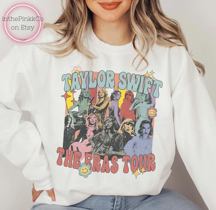 a woman wearing a white taylor swift sweatshirt with the words taylor swift and other characters on it