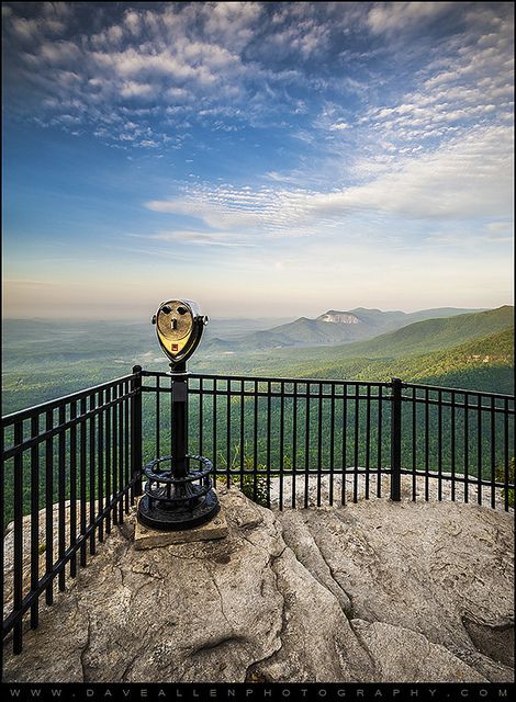 a view from the top of a mountain with a trophy on it's pedestal