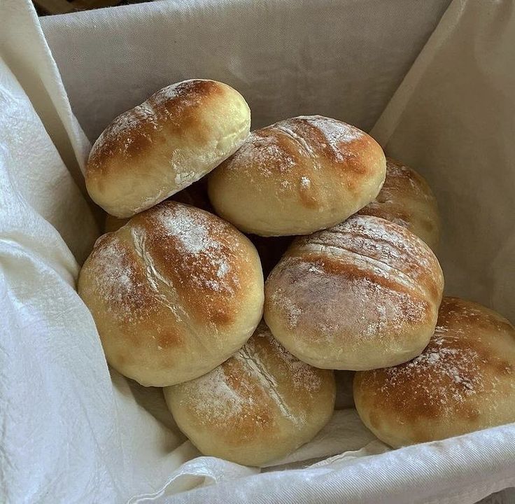 a bunch of bread rolls in a basket