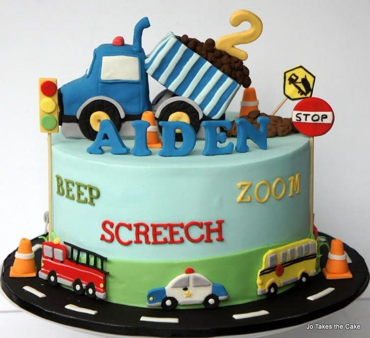 a birthday cake with cars and trucks on it