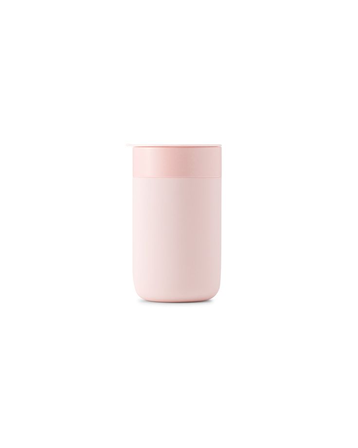 a pink cup sitting on top of a white table