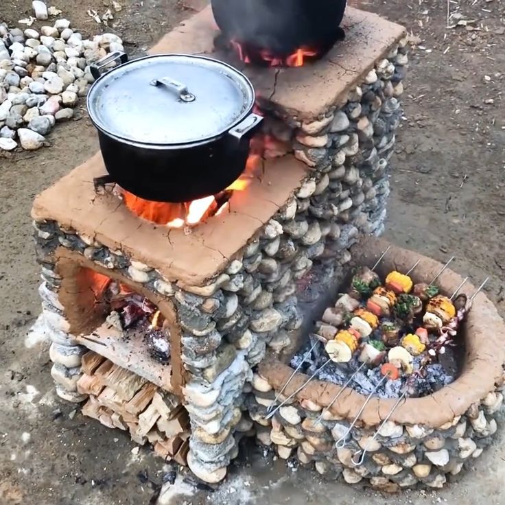 an outdoor grill made out of bricks and logs with a pot on top that is cooking food