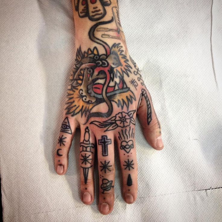 a person with tattoos on their hand and fingers