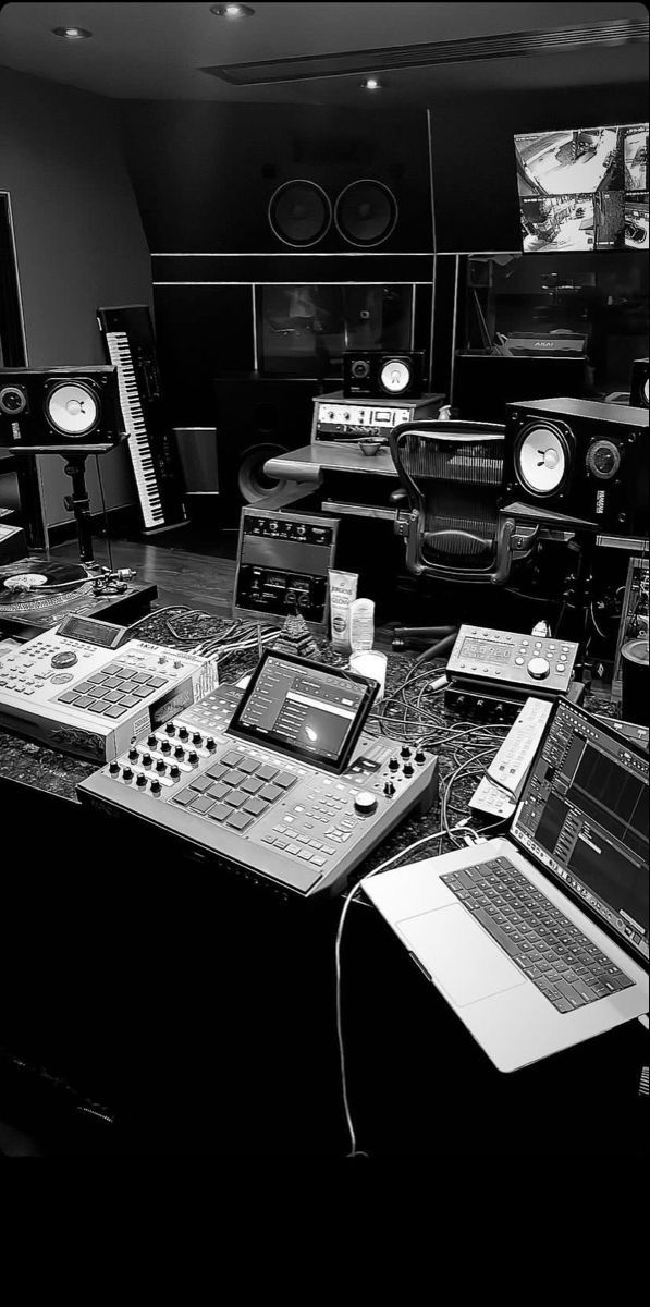 there are many electronic equipment on the table in this room and one is black and white