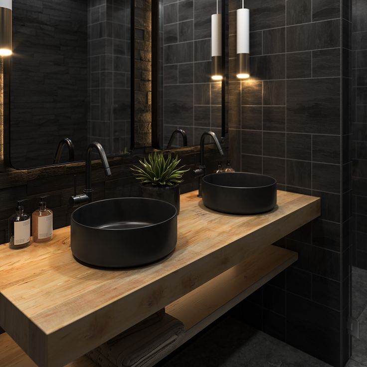 a bathroom with two sinks and mirrors on the wall next to each other in front of a large mirror