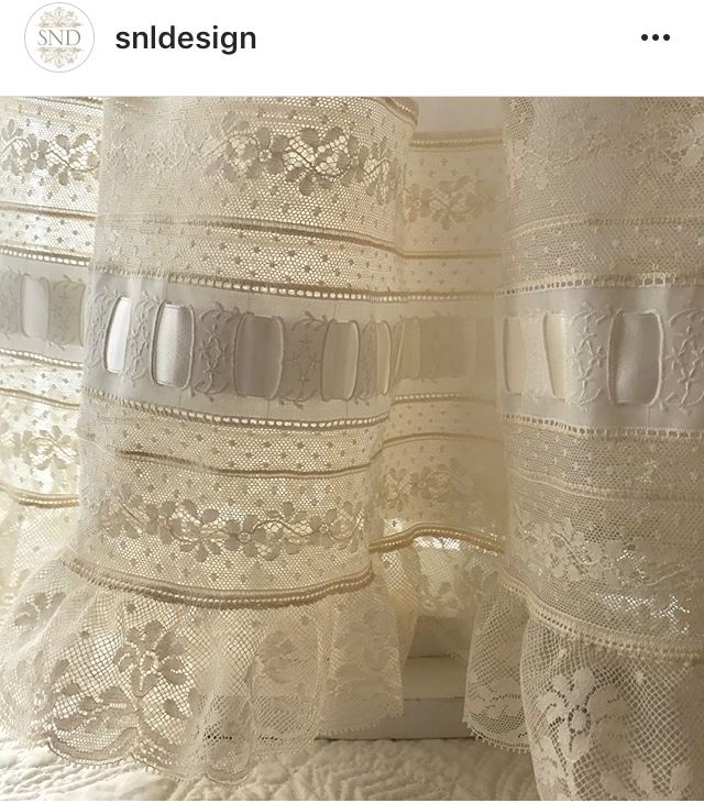 there is a white curtain with lace on it